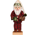 Decorative Santa figurine in plaid outfit holding a mug and cookie on a white background