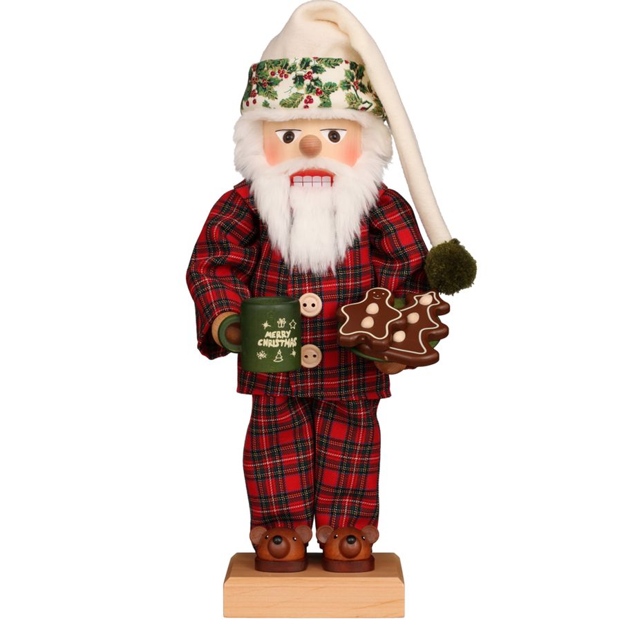 Decorative Santa figurine in plaid outfit holding a mug and cookie on a white background