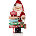 Santa Claus figure holding a signboard with various destinations on a white background