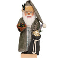 Decorative figure of a man with a beard, holding a bowl of olives and a gift, on a white background.