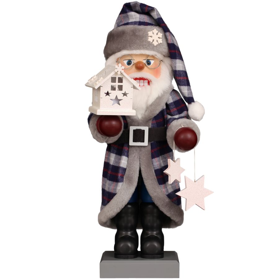Decorative figure of a Santa Claus holding a house-shaped lantern on a white background