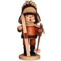 Wooden figurine of a skier with a hat and skis on a white background