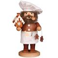 Wooden figurine of a chef with a beard, holding a gingerbread house and other items, on a white background.
