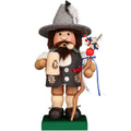 Traditional German wooden figurine with a hat and decorative items on a white background
