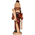 Wooden nutcracker figurine with traditional attire on a white background