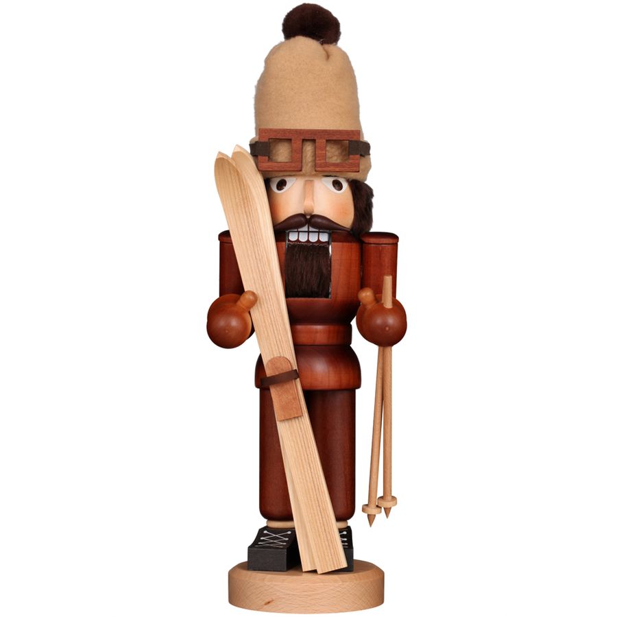 Wooden nutcracker figurine with traditional attire on a white background