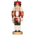 Wooden nutcracker figurine dressed as a king on a white background