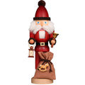 Decorative figure of a Santa Claus holding a lantern and a bag on a white background