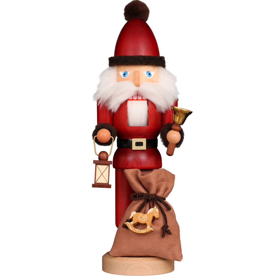 Decorative figure of a Santa Claus holding a lantern and a bag on a white background