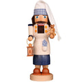 Wooden figurine of a man holding a teddy bear and lantern on a white background