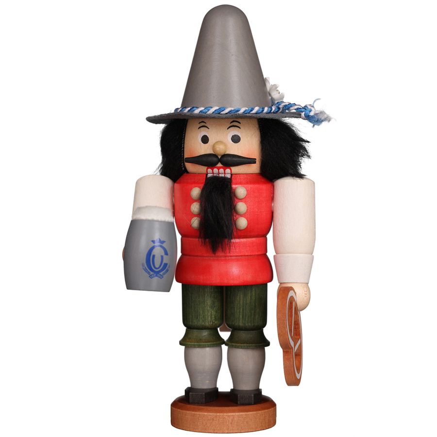 Wooden nutcracker figurine with traditional attire on a white background