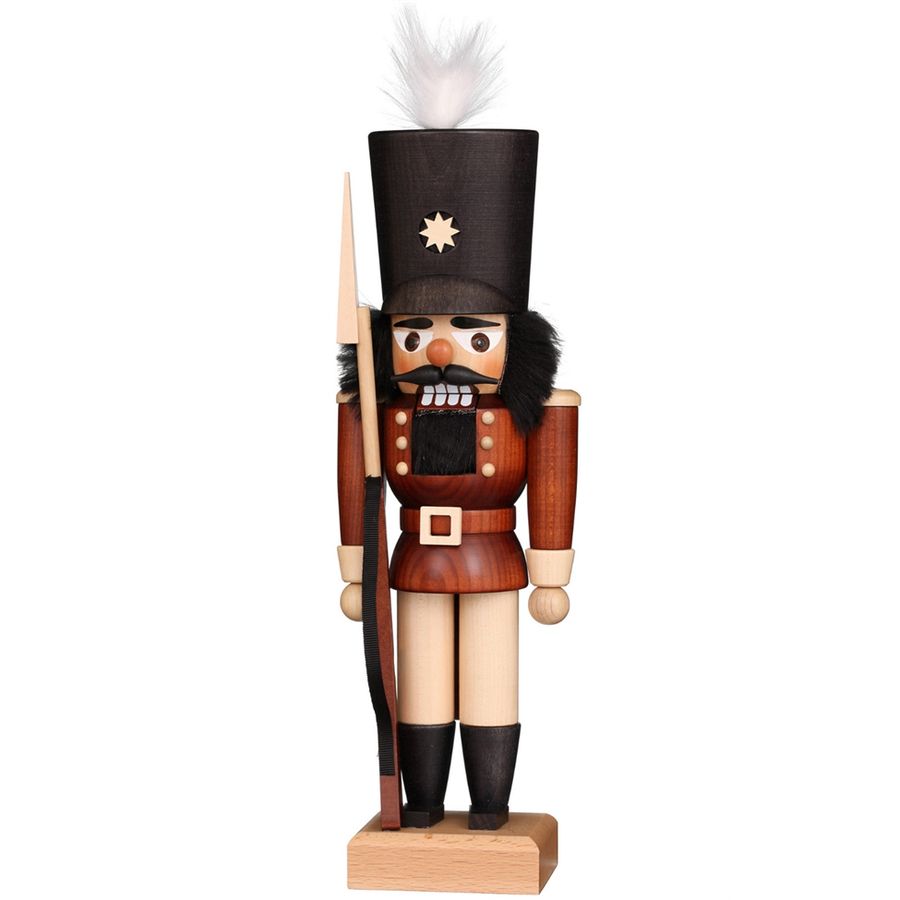 Wooden nutcracker figurine with a black hat and spear on a white background