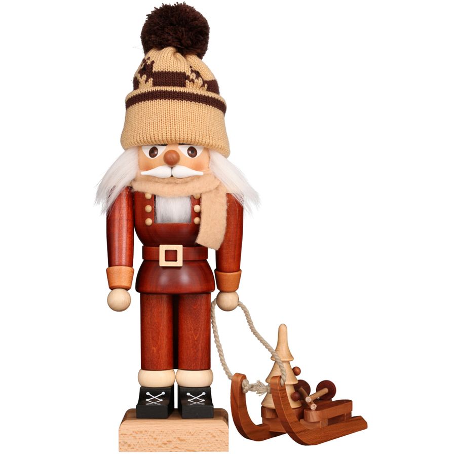 Wooden nutcracker figure with a hat and a small sled on a white background