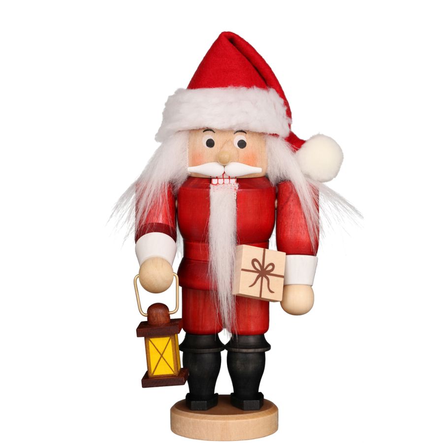 Wooden Santa Claus figurine holding a lantern and gift box on a white background