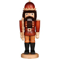 Wooden nutcracker figurine with a red hat and beard on a white background