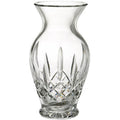 Clear glass vase with intricate cut patterns on a white background