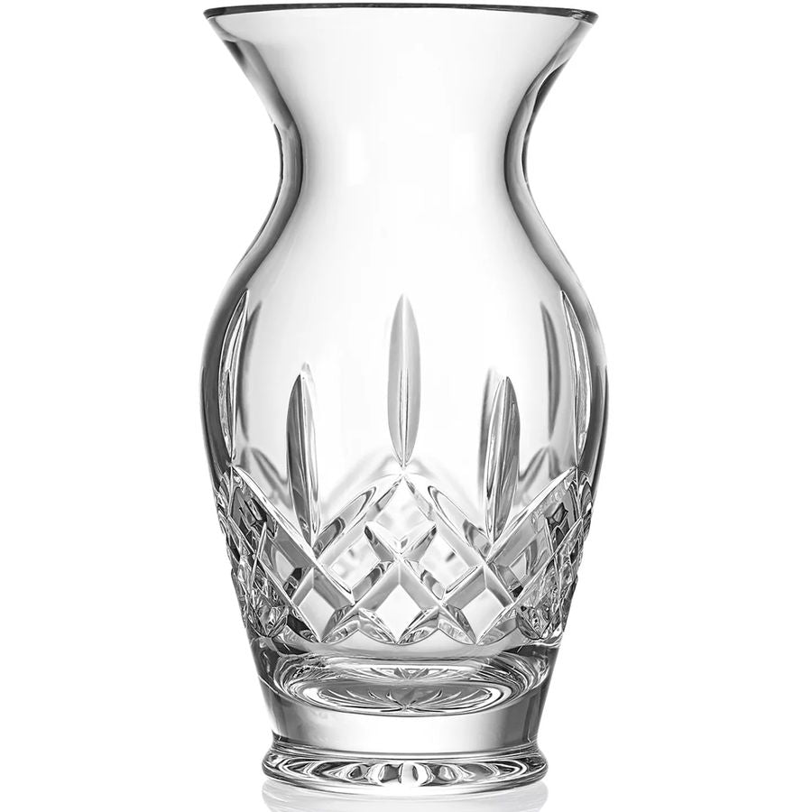 Clear glass vase with intricate cut patterns on a white background