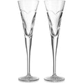 Two clear champagne flutes on a white background